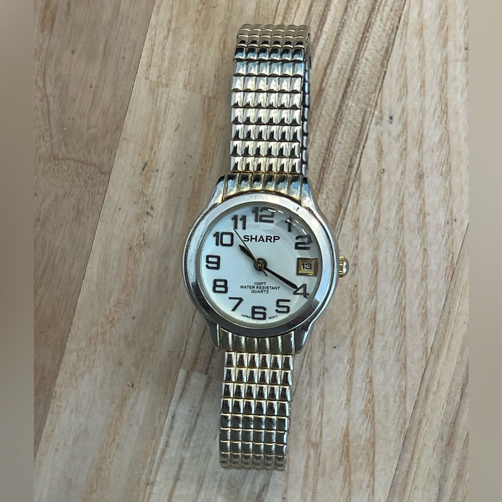 Sharp Ladies Watch Gold Tone Stretch Bracelet White Dial Date Window
